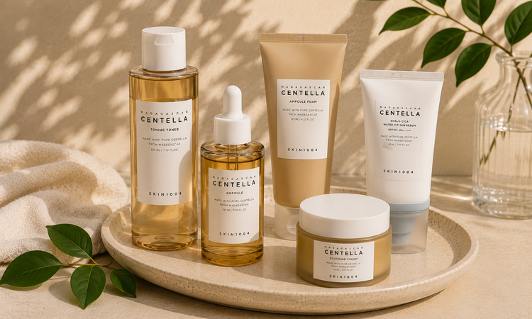 SKIN1004 Korean skincare products including cleanser, toner, serum, moisturizer, and sunscreen displayed in a minimalist natural skincare setting.